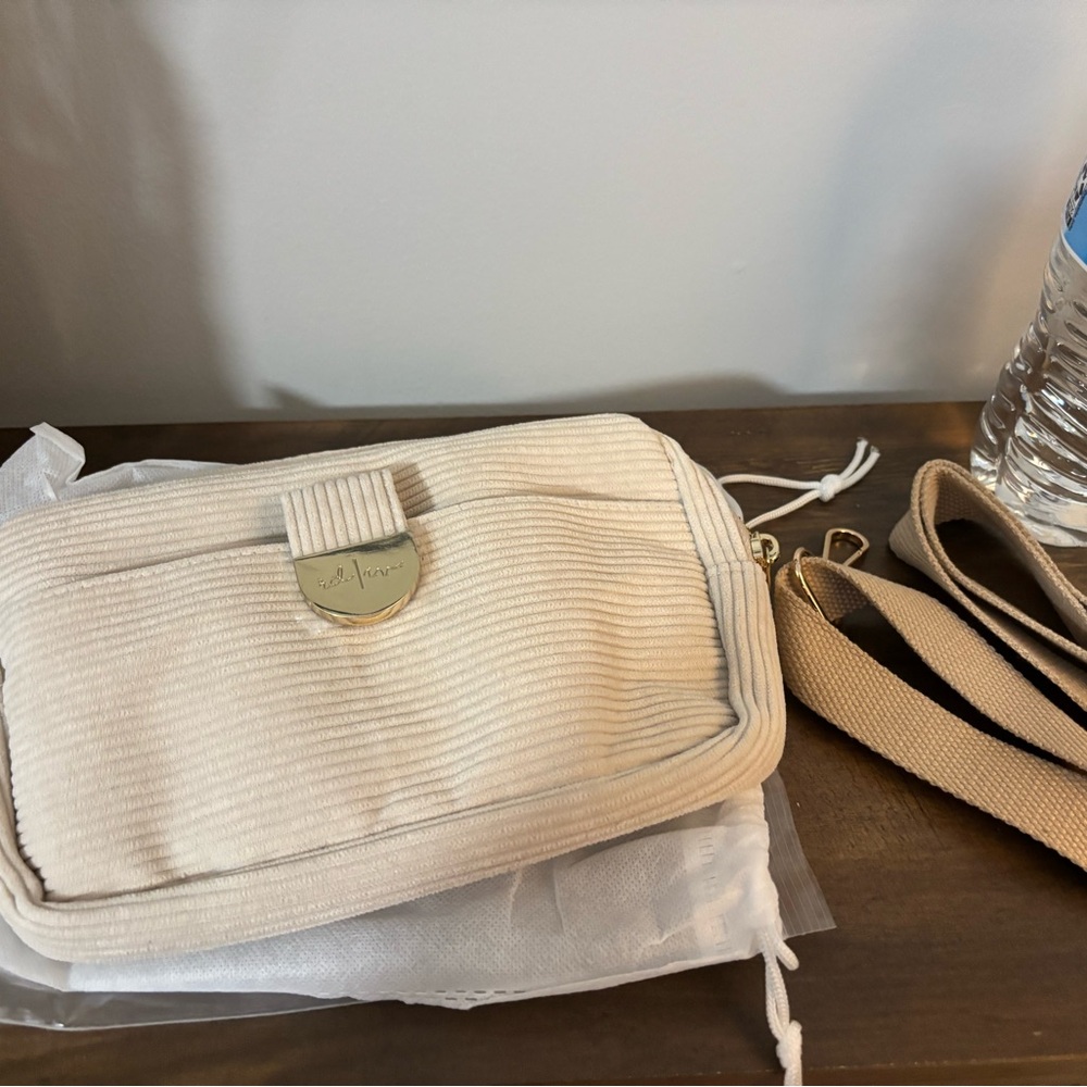 Rad rev cream convertible purse with card slots.